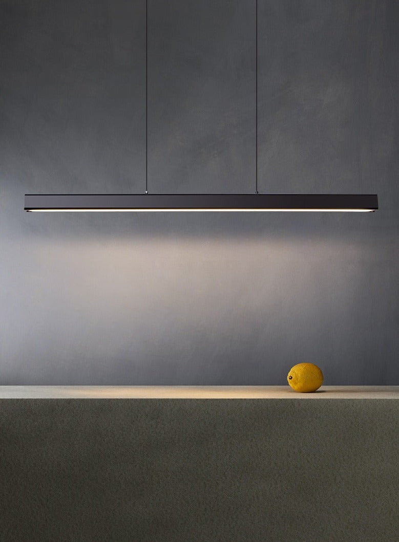 Elegant rectangular LED pendant light hanging above a stone table in a modern dining room.