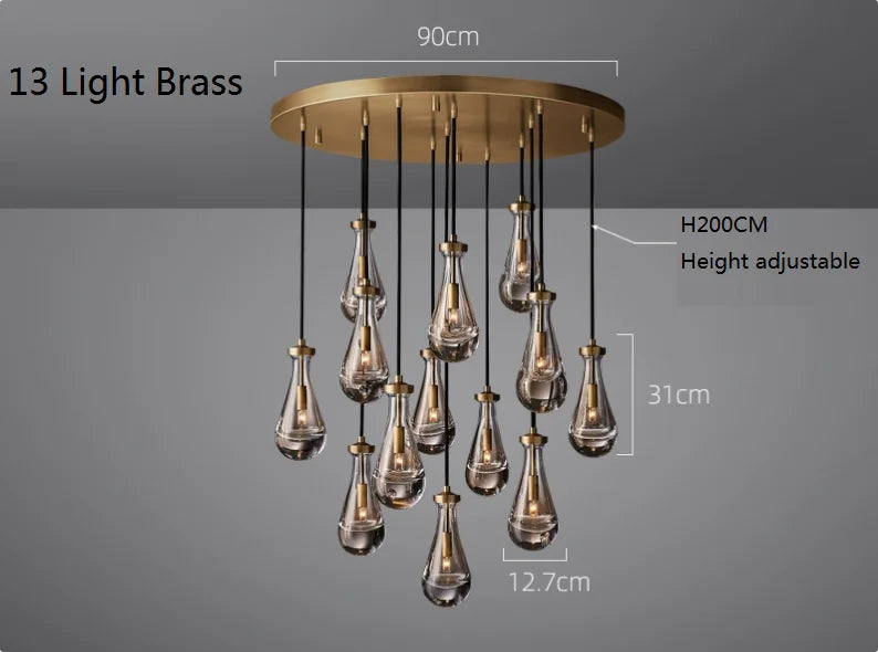 Raine Modern Chandelier with K9 crystal prisms and sleek metal design, perfect for high-ceiling living rooms, foyers, and upscale interiors. Adjustable height, energy-efficient LED compatible.