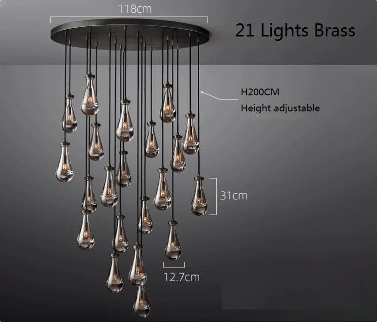 Raine Modern Chandelier with K9 crystal prisms and sleek metal design, perfect for high-ceiling living rooms, foyers, and upscale interiors. Adjustable height, energy-efficient LED compatible.