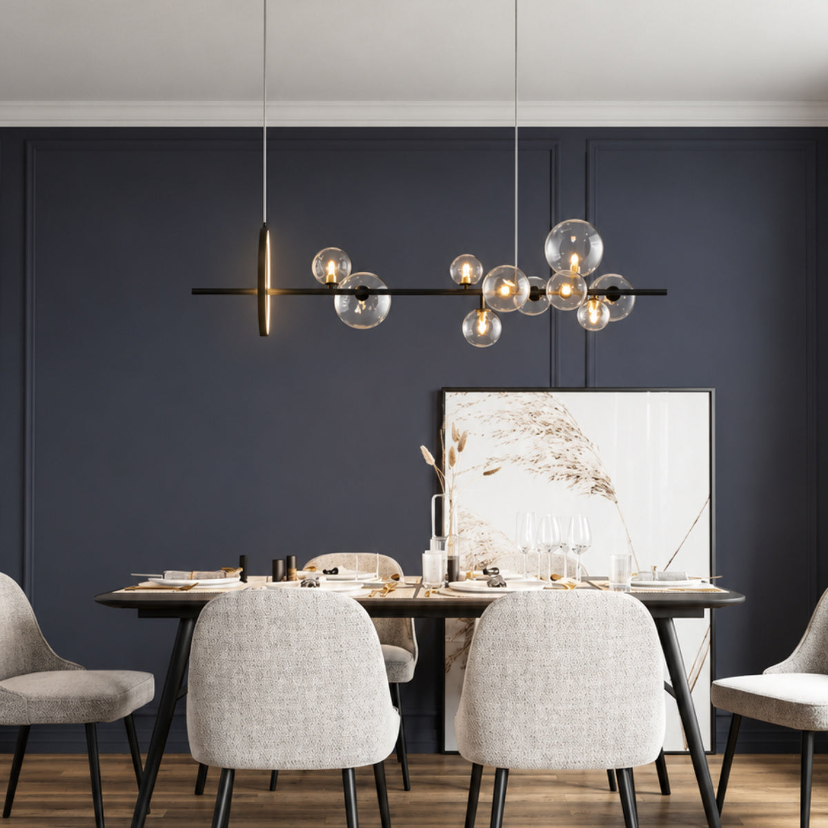 Modern dining room featuring a linear black pendant light with multiple clear glass globes, hanging above a dark wood dining table with light gray upholstered chairs against a dark navy paneled wall.