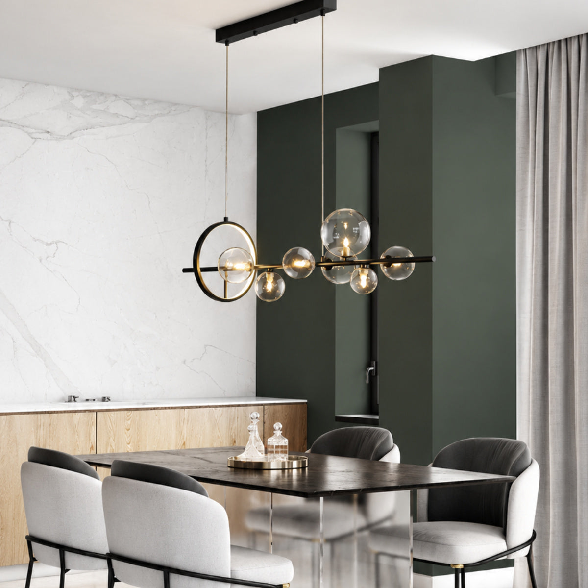 Modern multi-light linear chandelier with clear glass bubble globes and a gold-toned circular ring accent, hanging over a dining table in a contemporary dining room.