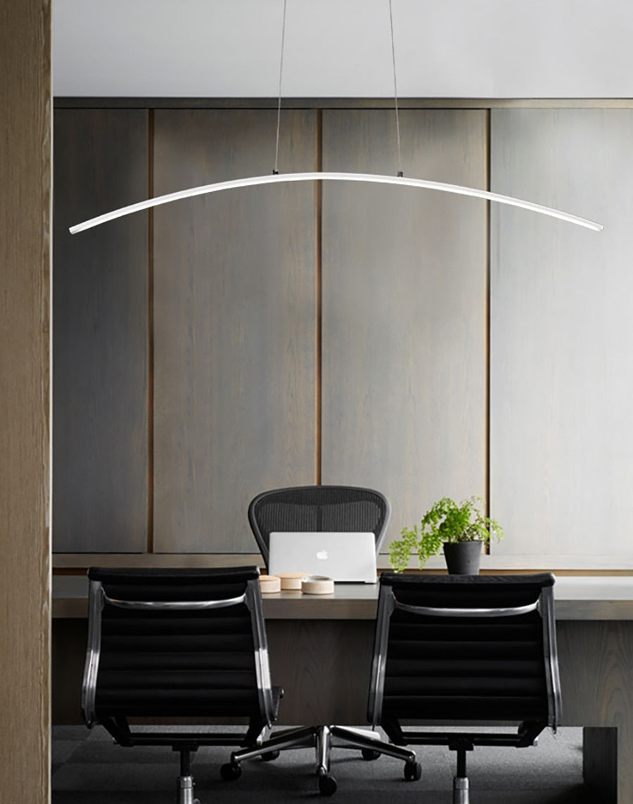 White LED pendant light with a curved design, installed in a office.